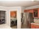 Well-lit kitchen area featuring stainless steel refrigerator and access to the laundry room at 1401 Runningbrook Ln, Avon, IN 46123