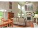 Bright living room with a fireplace, hardwood floors, and large windows for ample light at 1401 Runningbrook Ln, Avon, IN 46123