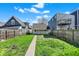 Backyard with green grass, a cement walkway, and a wooden fence at 1422 Olive St, Indianapolis, IN 46203