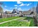 View of a green backyard with grass, leading to the back of the house, including an attached, covered patio at 1422 Olive St, Indianapolis, IN 46203