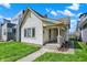 Quaint single-story home featuring a welcoming front porch, classic columns, and tidy landscaping at 1422 Olive St, Indianapolis, IN 46203