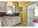 Cozy kitchen with traditional cabinetry and a view into an adjacent room at 1422 Olive St, Indianapolis, IN 46203