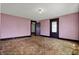 A living room with pink striped wallpaper and original dark trim at 1422 Olive St, Indianapolis, IN 46203