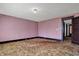 A living room with pink striped wallpaper and original dark trim at 1422 Olive St, Indianapolis, IN 46203