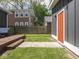 Well maintained backyard, showing a deck with steps and a fenced in yard with an orange door at 1430 Fletcher Ave, Indianapolis, IN 46203