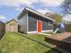 Backyard with a lawn, an outbuilding with an orange door, and outdoor toys at 1430 Fletcher Ave, Indianapolis, IN 46203