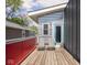 Outdoor balcony with modern design, two chairs and painted red metal railing at 1430 Fletcher Ave, Indianapolis, IN 46203