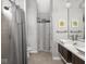Modern bathroom with vessel sinks, wood cabinets, tile floors, and a walk-in shower at 1430 Fletcher Ave, Indianapolis, IN 46203