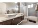 Modern bathroom features double sinks, stainless steel fixtures, and a shower-tub combination at 1430 Fletcher Ave, Indianapolis, IN 46203