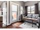 Cozy sitting area features a gray couch, small table, and natural light from a sliding glass door at 1430 Fletcher Ave, Indianapolis, IN 46203