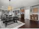 Open-concept dining and kitchen area with modern gray cabinets and hardwood floors throughout at 1430 Fletcher Ave, Indianapolis, IN 46203