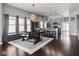Open floor plan dining room featuring dark hardwood floors and modern light fixtures at 1430 Fletcher Ave, Indianapolis, IN 46203