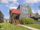 Modern two-story home with gray exterior, red awning, cozy front porch, and manicured lawn at 1430 Fletcher Ave, Indianapolis, IN 46203