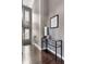 Hallway with hardwood floors, chandelier and table with decor at 1430 Fletcher Ave, Indianapolis, IN 46203