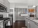 This kitchen showcases gray cabinetry, stainless steel appliances, and beautiful granite countertops at 1430 Fletcher Ave, Indianapolis, IN 46203