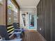 Inviting porch with wooden floors, seating and a bright blue front door at 1430 Fletcher Ave, Indianapolis, IN 46203