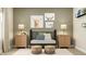 Cozy Bedroom with charming decor, including framed highland cow prints and matching lamps on side tables, enhancing the inviting space at 15388 Manderley St, Fishers, IN 46040