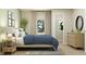 Stylish bedroom featuring a cozy bed, chic decor, a plant, and a walk-in closet, creating a serene and inviting space at 15388 Manderley St, Fishers, IN 46040