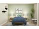 Charming bedroom with light green walls, dinosaur art, a cozy bed with throw pillows and a plant on the side table at 15388 Manderley St, Fishers, IN 46040
