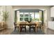 Elegant dining room with a wooden table, stylish chairs, and large windows that let in natural light at 15388 Manderley St, Fishers, IN 46040