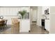 Bright kitchen boasts white cabinets, stainless steel appliances, and a large island with counter seating at 15388 Manderley St, Fishers, IN 46040