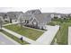 A beautiful home with a well-manicured lawn, landscaping, a basketball court, and an attached garage at 15594 Garrano Ln, Fishers, IN 46040