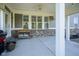 Back porch with ceiling fan, multiple windows, and space for dining and relaxation at 15594 Garrano Ln, Fishers, IN 46040