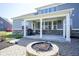Captivating backyard with a stone fire pit, outdoor lights, and a charming covered patio for social gatherings at 15594 Garrano Ln, Fishers, IN 46040