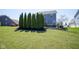 Well-manicured backyard showcases lush grass, lovely green trees, and clean landscaping for a beautiful view at 15594 Garrano Ln, Fishers, IN 46040