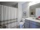 Clean bathroom featuring a shower with a curtain, a toilet, a gray vanity, and a framed mirror at 15594 Garrano Ln, Fishers, IN 46040