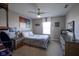 Cozy bedroom with a ceiling fan, window, and unique decor, creating a comfortable and personalized space at 15594 Garrano Ln, Fishers, IN 46040