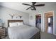 Relaxing bedroom boasts ceiling fan, modern decor, and convenient access to the closet with built-in storage at 15594 Garrano Ln, Fishers, IN 46040