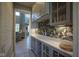 Stylish butler's pantry with glass-front cabinets, unique backsplash, and ample counter space at 15594 Garrano Ln, Fishers, IN 46040