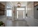 Bright foyer featuring classic trim, a hanging light fixture, and light-colored plank flooring at 15594 Garrano Ln, Fishers, IN 46040