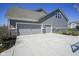 Three car garage with large driveway and well manicured landscaping for this beautiful home at 15594 Garrano Ln, Fishers, IN 46040