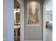 Hallway view showing alcove with decorative display between bathroom and bedroom doorways at 15594 Garrano Ln, Fishers, IN 46040