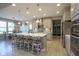 Bright kitchen with island, breakfast bar seating, stainless appliances, and light gray cabinets at 15594 Garrano Ln, Fishers, IN 46040
