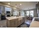 Open kitchen layout features an island with a sink and flows into living and dining areas at 15594 Garrano Ln, Fishers, IN 46040