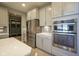 The kitchen boasts stainless steel appliances, light gray cabinetry, and ample counter space at 15594 Garrano Ln, Fishers, IN 46040