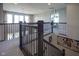 Elegant second-floor landing with decorative iron railing overlooking the staircase and views of the living spaces at 15594 Garrano Ln, Fishers, IN 46040