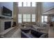 Comfortable living room with a stone fireplace, ample seating, and high ceilings at 15594 Garrano Ln, Fishers, IN 46040