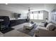 Spacious living room with sleek built-ins, comfortable seating, and a large window, ideal for relaxation and entertainment at 15594 Garrano Ln, Fishers, IN 46040
