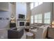 Bright and airy living room with a stone fireplace, high ceilings, and neutral decor at 15594 Garrano Ln, Fishers, IN 46040