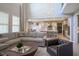 Open-concept living room flows into kitchen, showcasing a large sectional sofa and neutral color palette at 15594 Garrano Ln, Fishers, IN 46040