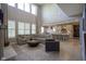 Spacious living room with a large sectional, fireplace, and open layout to the kitchen at 15594 Garrano Ln, Fishers, IN 46040