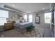 Bright main bedroom showcases tray ceiling, neutral palette, with large windows, and modern decor at 15594 Garrano Ln, Fishers, IN 46040