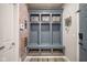 Mudroom with custom built-ins, storage, and a patterned accent wall for organization and style at 15594 Garrano Ln, Fishers, IN 46040