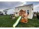 Lush backyard featuring a well-maintained lawn, and a wooden playset with a slide at 1583 Valdarno Dr, Greenwood, IN 46143