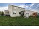 Expansive backyard with green lawn, patio seating, playset, and plenty of room to play at 1583 Valdarno Dr, Greenwood, IN 46143
