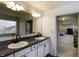 Dual vanity bathroom featuring granite countertops and a large mirror, connecting to other areas of the home at 1583 Valdarno Dr, Greenwood, IN 46143